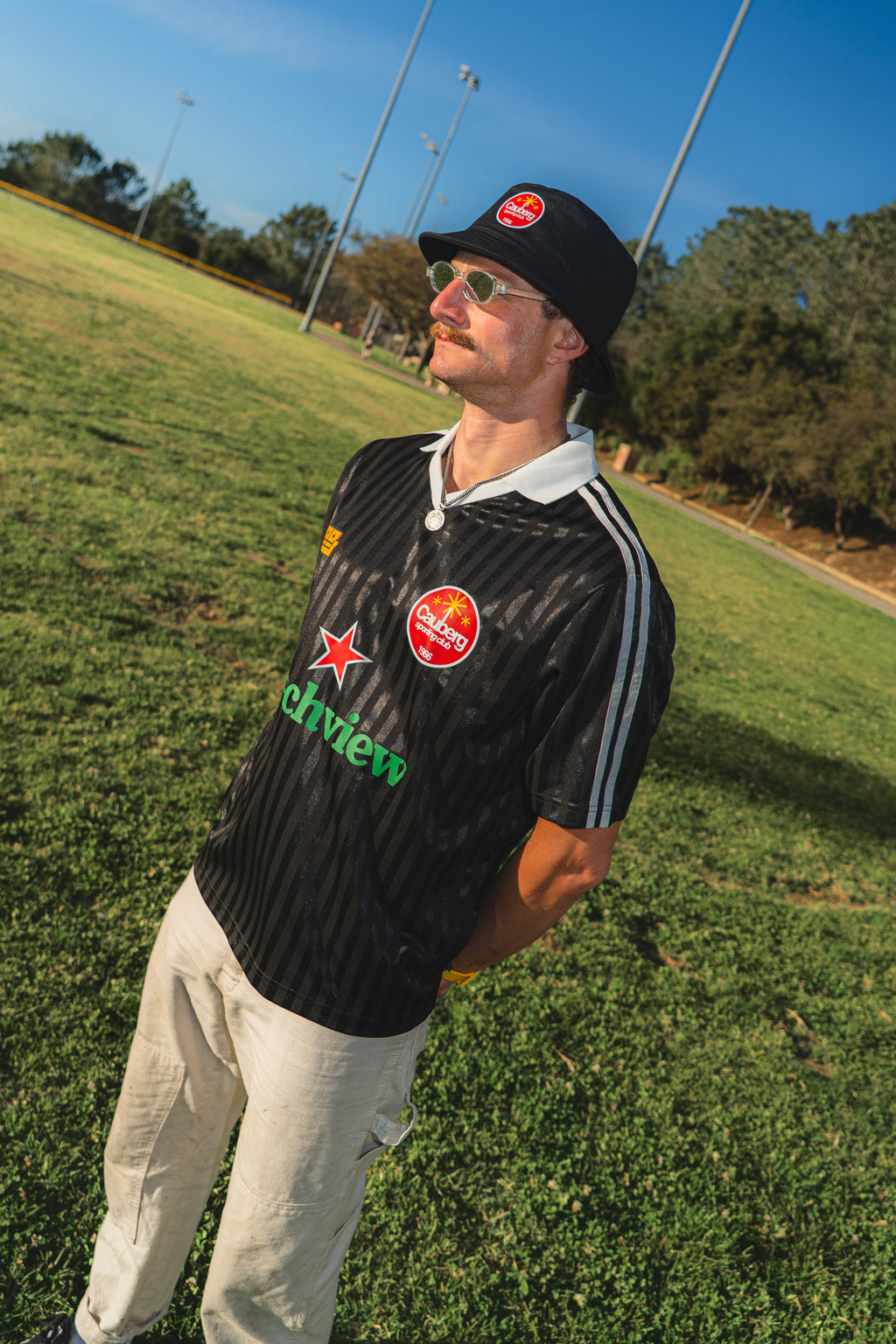 Man wearing a black couch view jersey on a grassy field